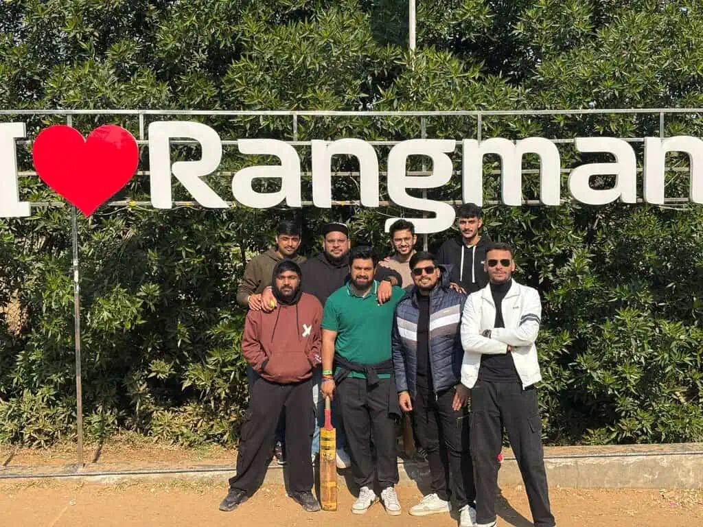D2i Technology team posing in front of the "I Love Rangman" sign during a team outing