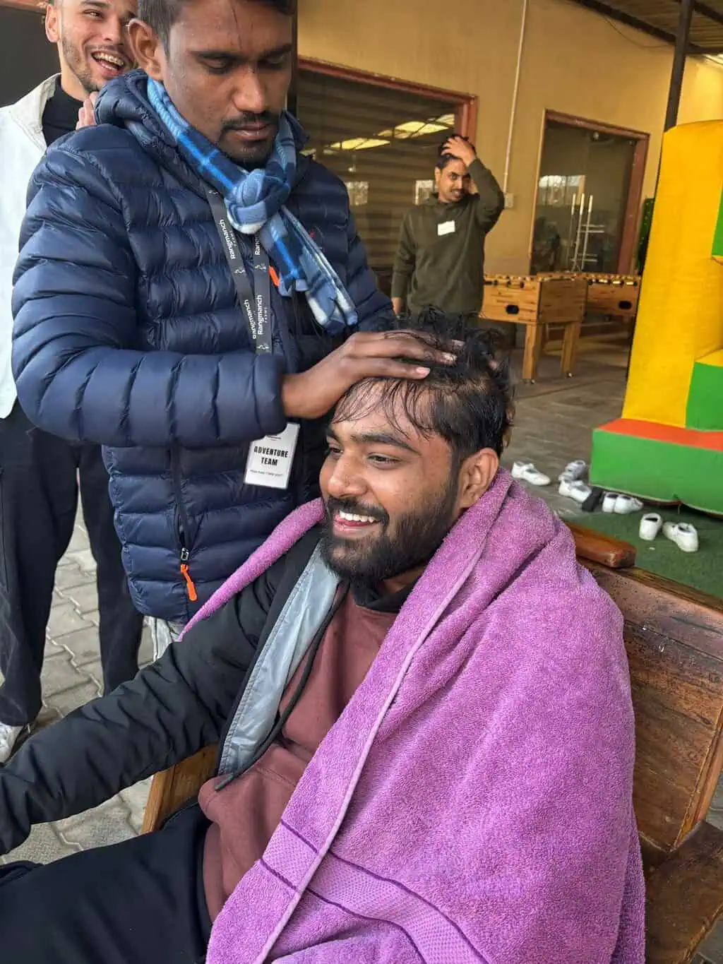 D2i Technology team member getting his head shaved as part of a fun team activity