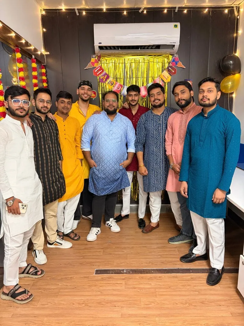 Group of colleagues in traditional kurtas standing together at the office.